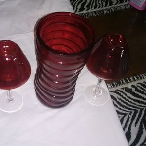Red rigged twisted vase and hurricane lamps candle